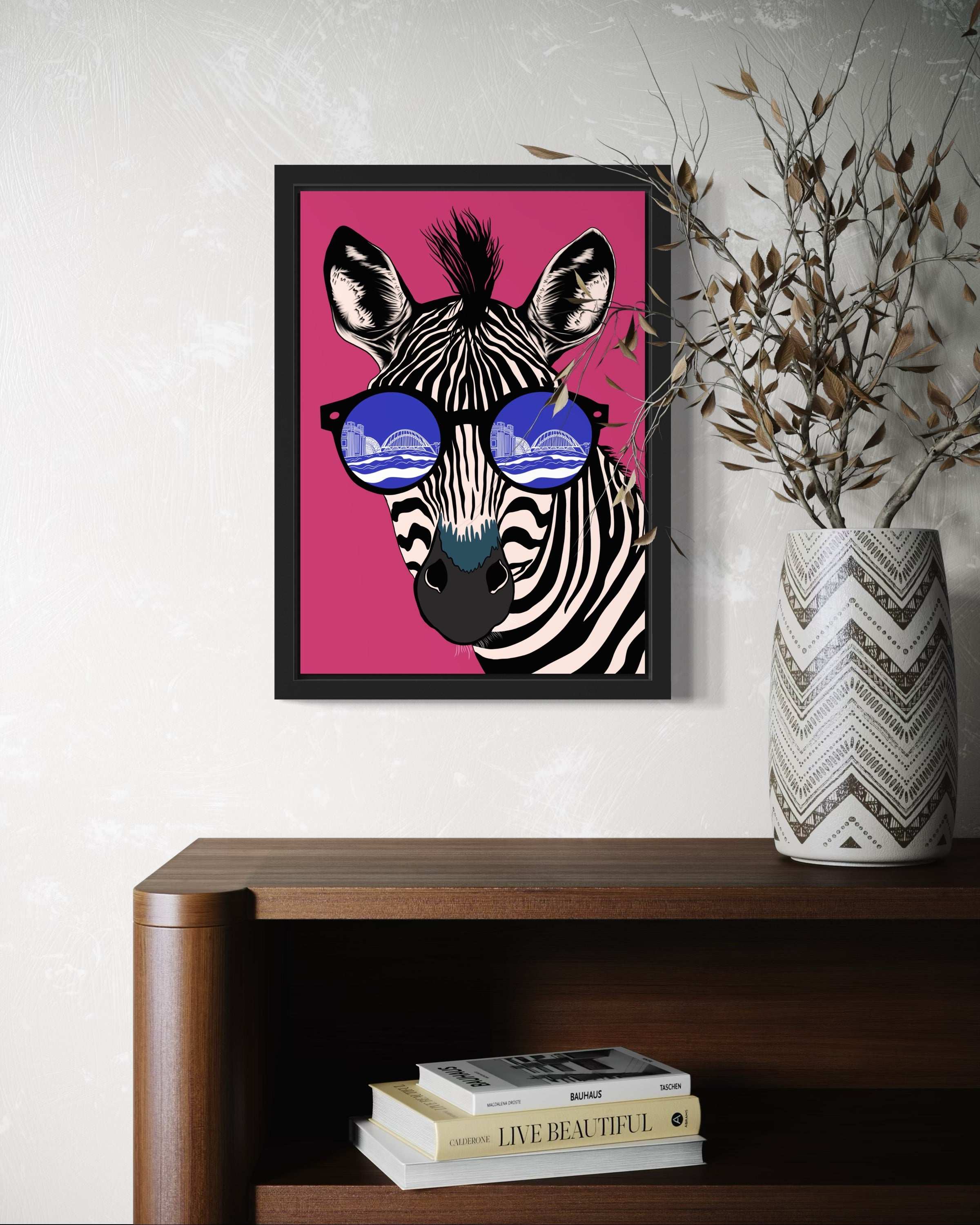 Zebra with Newcastle River Tyne in the reflection of its glasses art print. Pink and blue version framed on the wall of a entry hall.