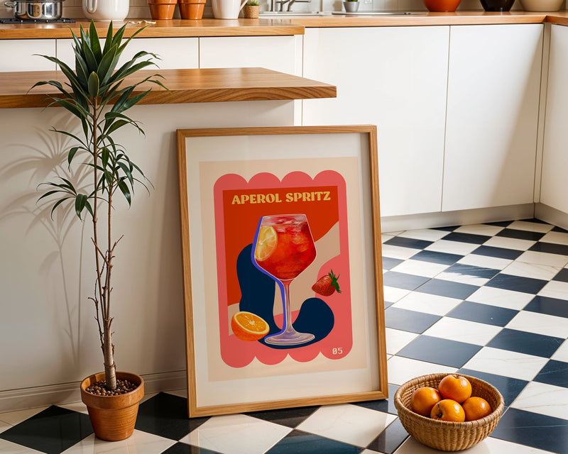A framed art print featuring an Aperol Spritz glass placed in a kitchen with a checkered floor