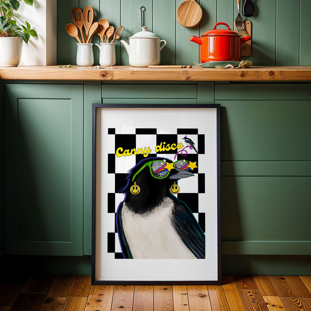 Framed artwork of a magpie with sunglasses in a kitchen setting with text that reads "Canny Disco"