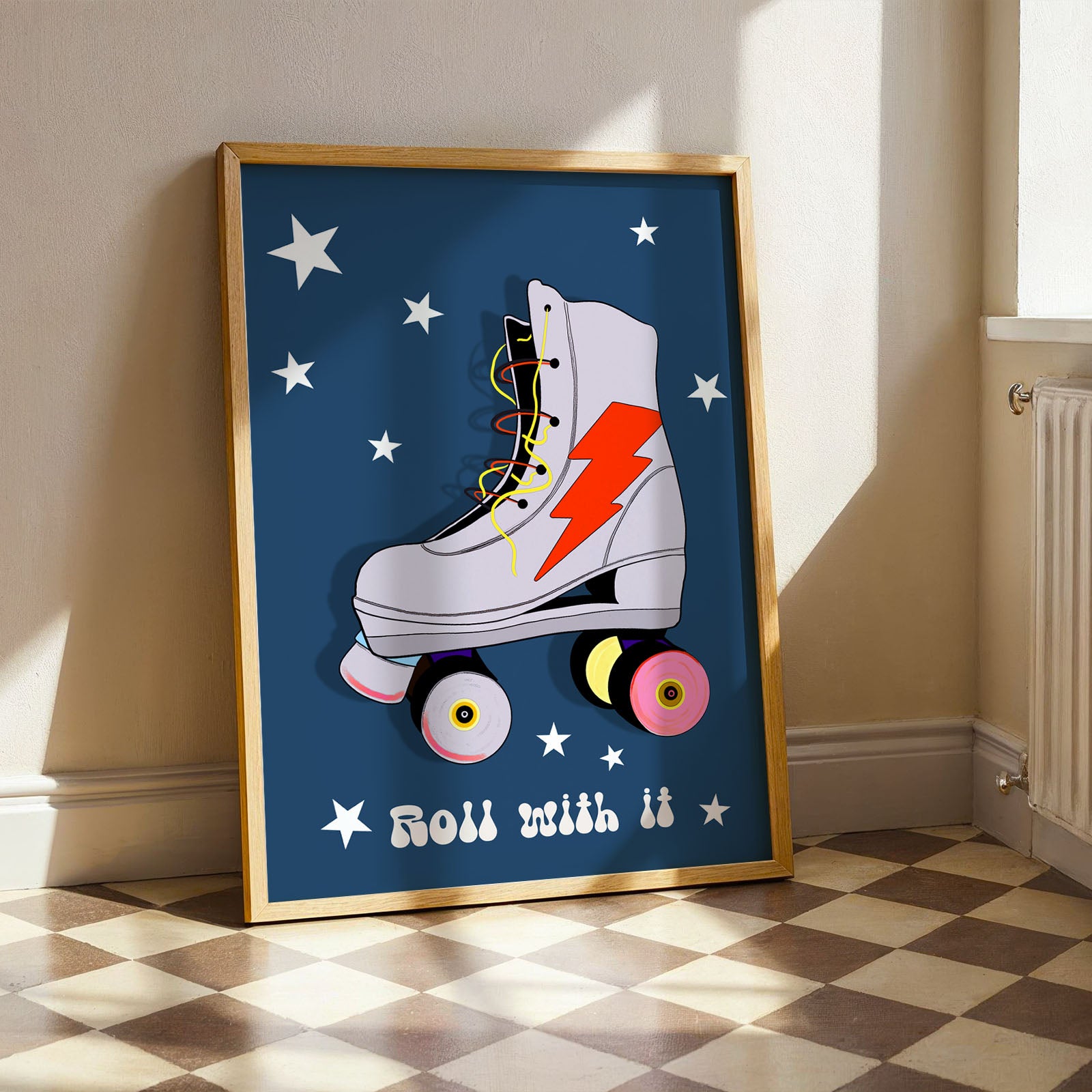 Print of a retro roller skate with a blue background, stars, lightening bolt, and 'Roll with it' text. Blue, pink and orange colours.